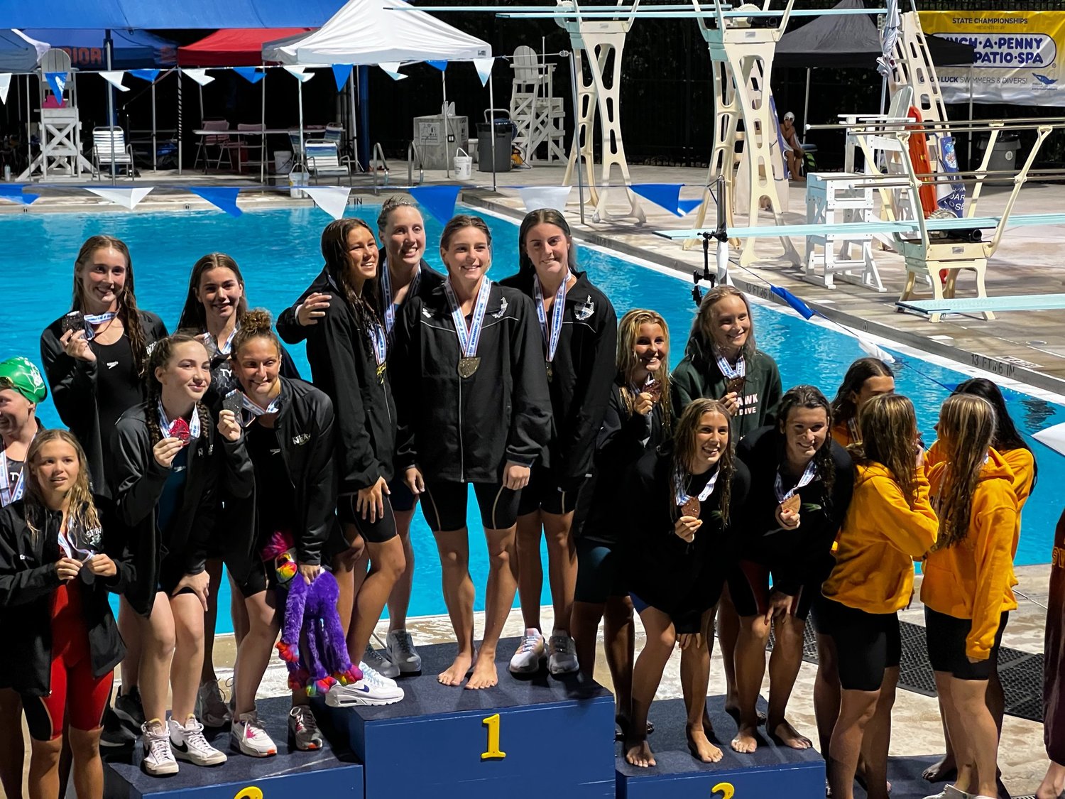 Ponte Vedra’s 200 freestyle girls relay team of Annie Wohlgemuth, Kate Pelot, Liv Copland and Penny Zarczynski stand on the top step of the podium.